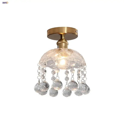 A modern luxury decorbites crystal glass ceiling lamp with brass finish and faceted spherical crystals for living room