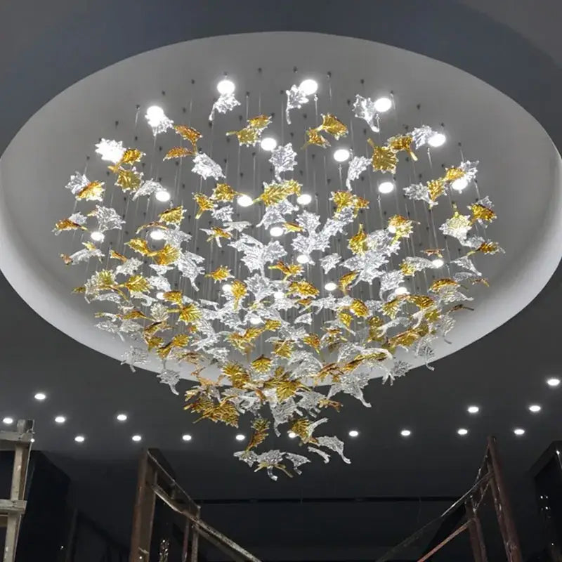 A modern luxury glass high ceiling led chandelier with intricate translucent gold and clear glass leaves for living room decorbites glass high