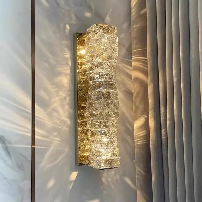 Modern luxury gold and crystal led wall light featuring a clear faceted crystal sconce with a gold-toned metal frame