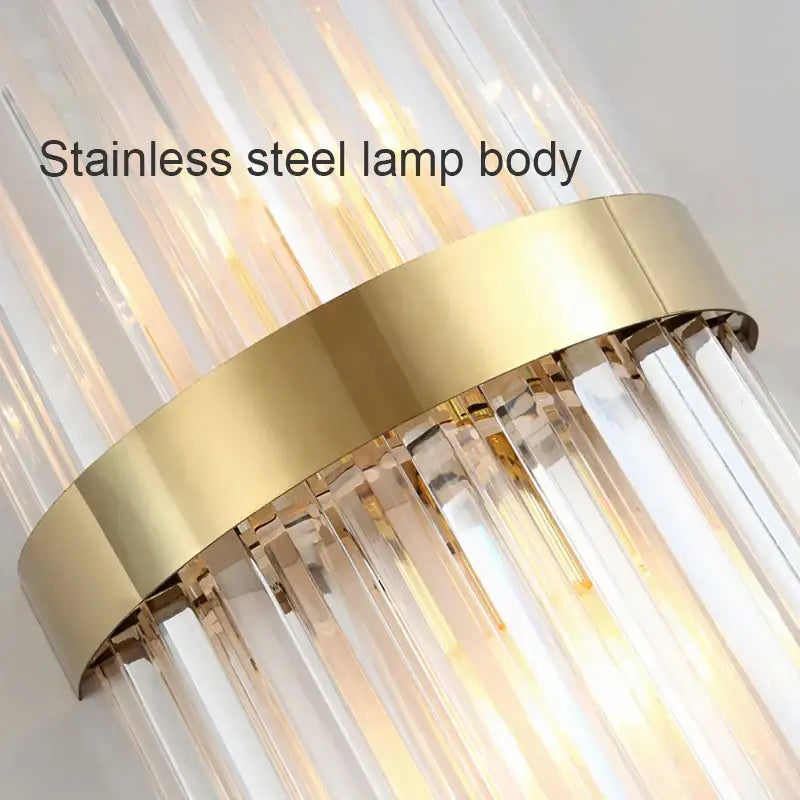 Modern luxury gold crystal led wall lamp with sleek stainless steel body and cascading clear crystal rods for bedroom decorbites crystal led