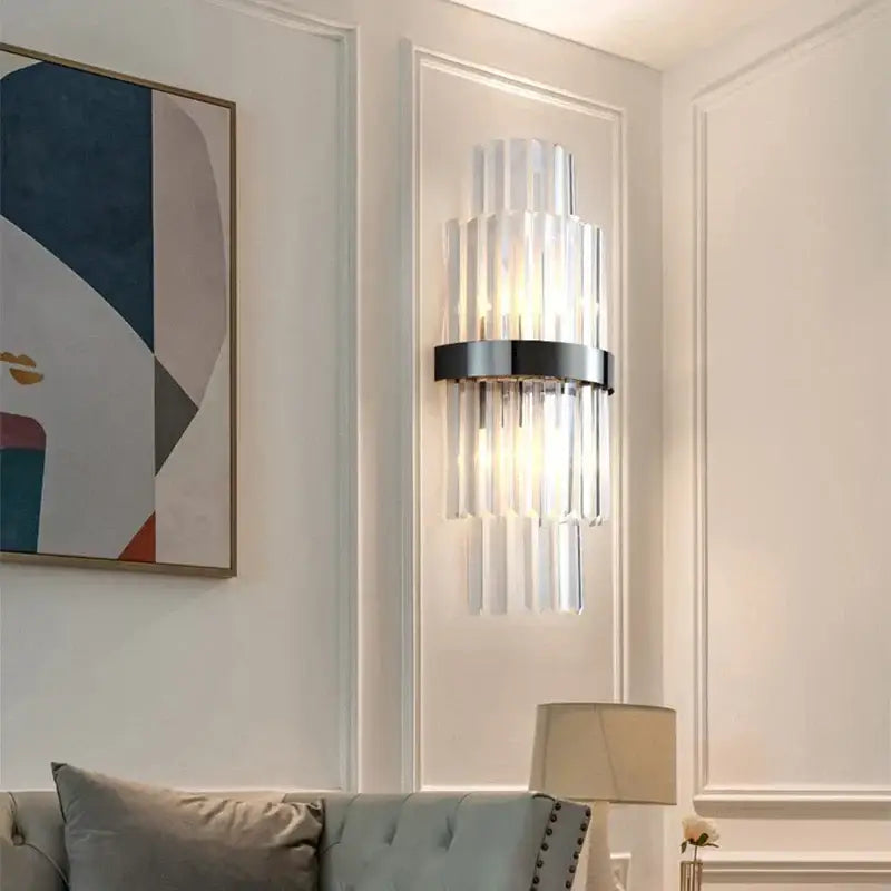 Modern luxury gold crystal led wall lamp with vertical crystal rods and sleek black metal base for bedroom decorbites crystal led