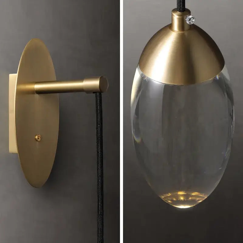 Brass-finished wall light with clear glass pendant and sleek modern design in decorbites crystal led wall sconce style