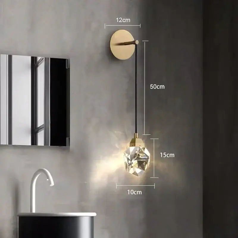 A modern luxury gold crystal led wall sconce with a faceted clear glass globe for bedroom decorbites crystal led lighting