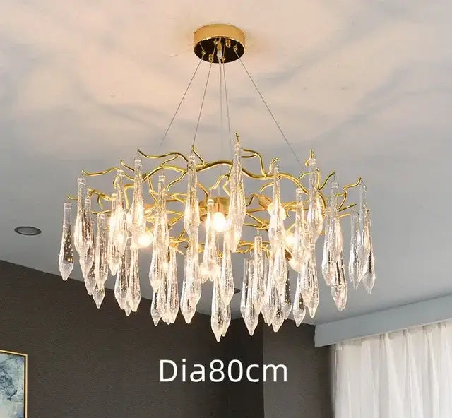 Modern luxury golden crystal water drop led chandelier with intricate branch-like arms and dangling crystal water pendants