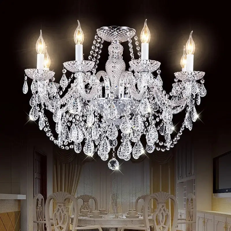 A sparkling crystal candle chandelier with multiple arms and teardrop crystals for modern luxury lighting in dining rooms