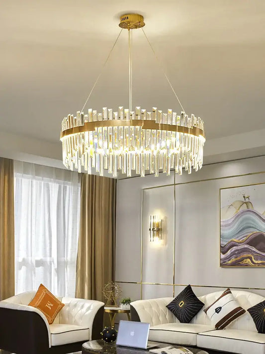 Modern luxury spectrum gold crystal chandelier with cascading clear crystal rods and a circular brass frame for dining room
