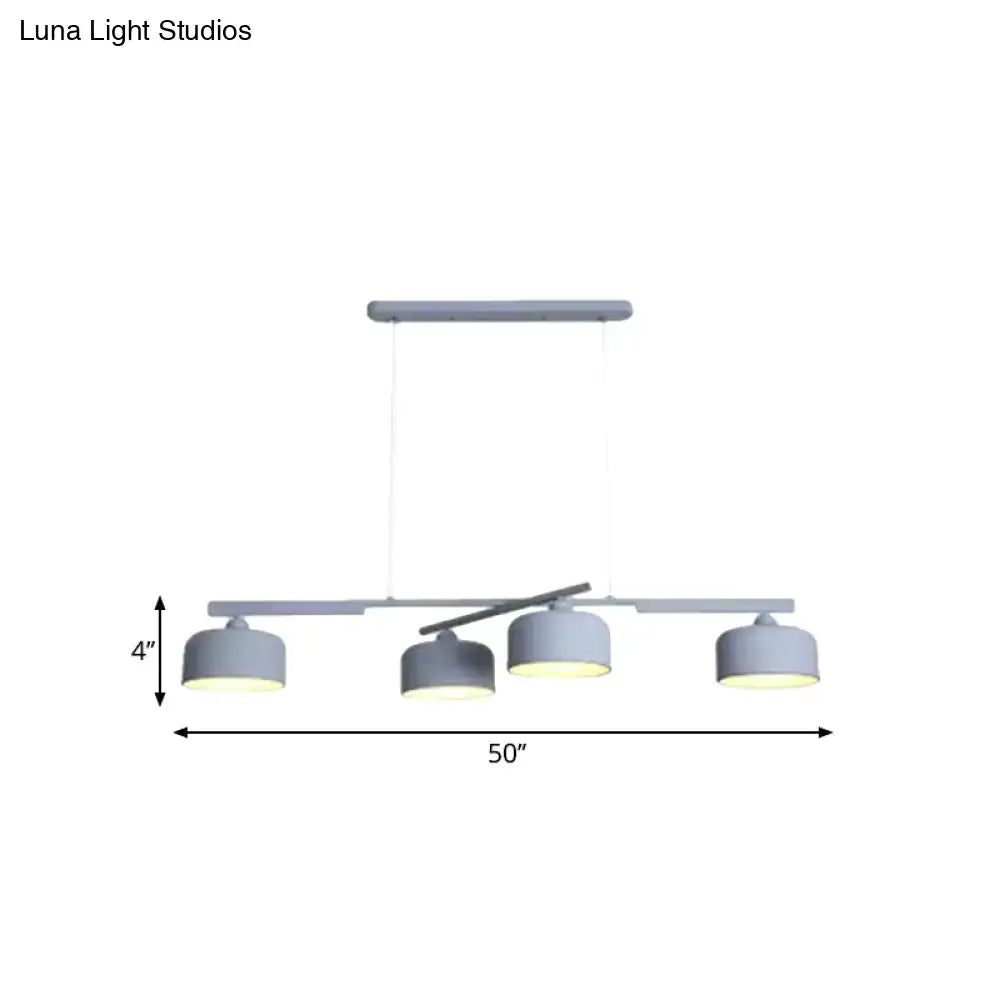 DecorBites modern gray metal pendant light with four cylindrical shades and adjustable chain cord length for dining table