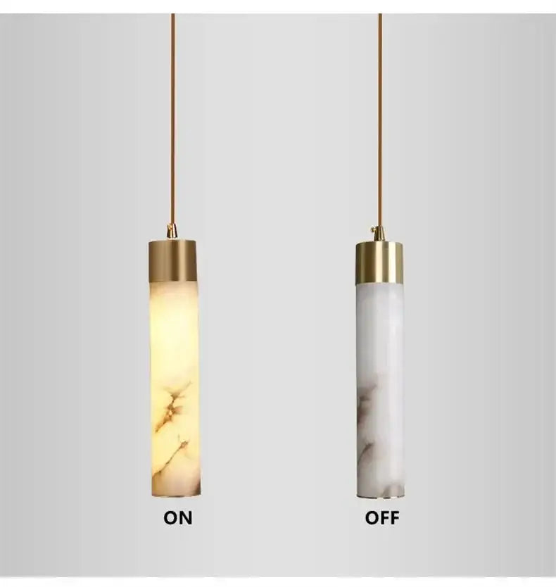 Two cylindrical modern marble and copper led pendant lights with gold-toned tops for bedroom decorbites copper led design