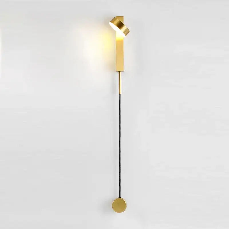 Gold-toned modern wall lamp with sleek twisted head and cylindrical base for decorbites black rotating led sconce