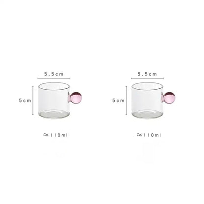 Modern marble sphere glass espresso cup with a pink spherical handle holding 110 ml of liquid in a kitchen set