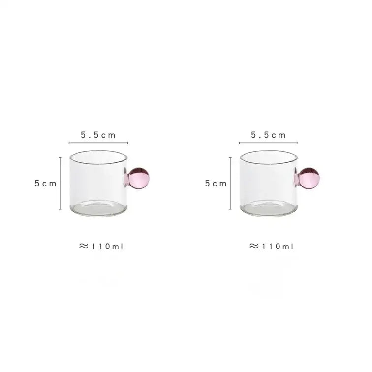 Modern marble sphere glass espresso cup with a pink spherical handle holding 110 ml of liquid in a kitchen set
