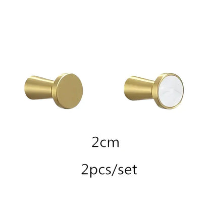 Modern marbled stone and decorbites brushed gold towel hook with gold metallic knob and white circular inlay for bathroom decor