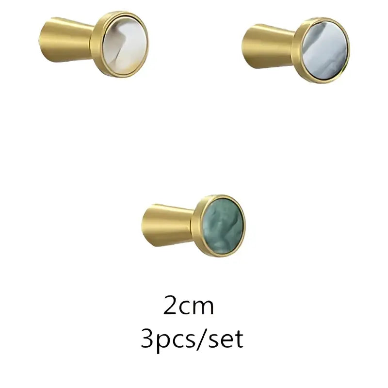 Gold-toned cabinet knobs with round marbled stone inlays in creamy white to grayish-blue for decorbites brushed gold towel hook bathroom decor