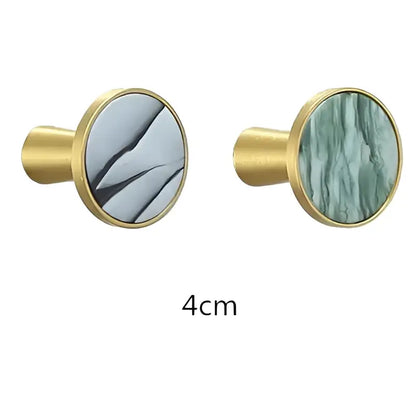 Modern marbled stone and decorbites brushed gold towel hook with gold-toned circular knobs and gray green marble faces