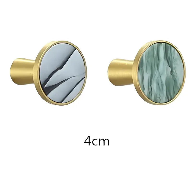 Modern marbled stone and decorbites brushed gold towel hook with gold-toned circular knobs and gray green marble faces
