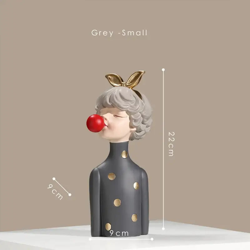 Grey resin bubble gum girl statue with gold polka dots and maroon bow blowing red bubblegum for bedroom decor