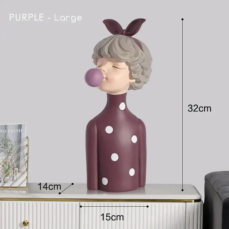Modern maroon and silver bubble gum girl statue featuring a purple figurine with short gray hair and polka-dotted dress