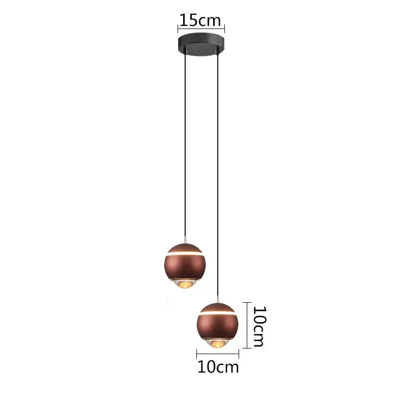 Modern matte copper-finished ball pendant lights with a sleek minimalist design for bedroom and kitchen island use