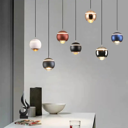 Modern matte ball pendant lights in white, brushed copper, black, and metallic blue for bedroom and kitchen island
