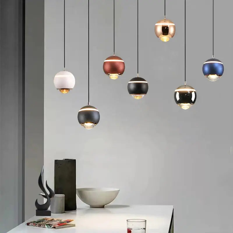 Modern matte ball pendant lights in white, brushed copper, black, and metallic blue for bedroom and kitchen island