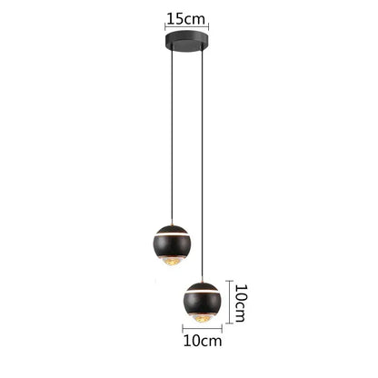 Modern matte black ball pendant lights with gold-toned accents designed for bedroom and kitchen island lighting