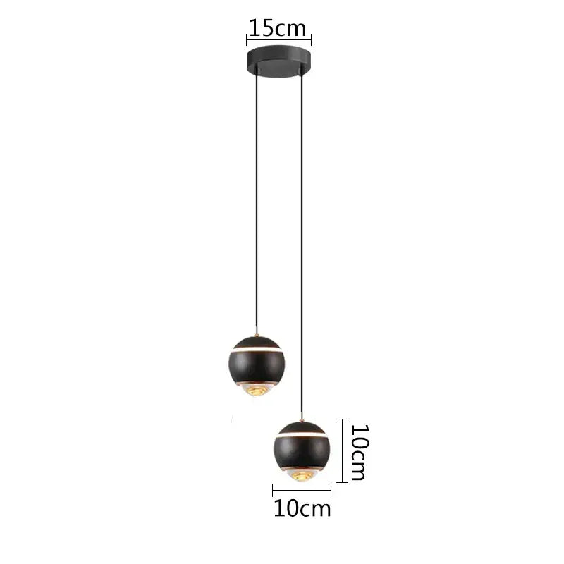 Modern matte black ball pendant lights with gold-toned accents designed for bedroom and kitchen island lighting