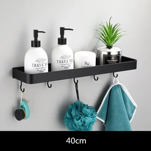 Modern matte black aluminum corner shelf with hooks holding toiletries and plant for black aluminum bathroom decorbites storage