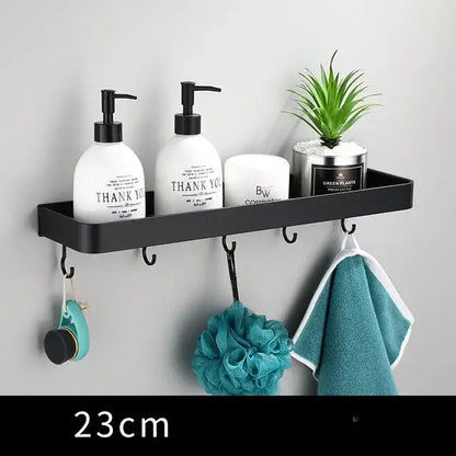 Modern matte black aluminum corner shelf with integrated hooks holding toiletries and plant decorbites black aluminum bathroom storage