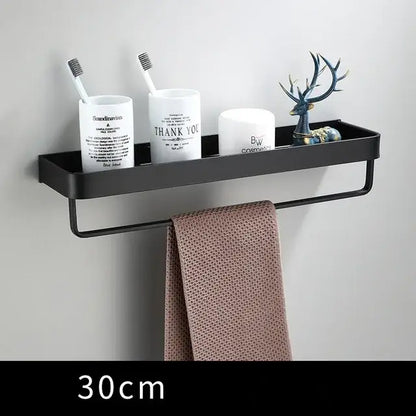 Modern matte black aluminum corner shelf with integrated towel rack holding decorbites black aluminum bathroom items