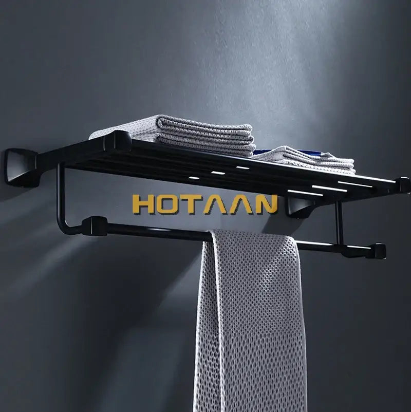 Modern matte black aluminum towel rack by decorbites featuring gold hotaaan branding and dual-tiered towel storage