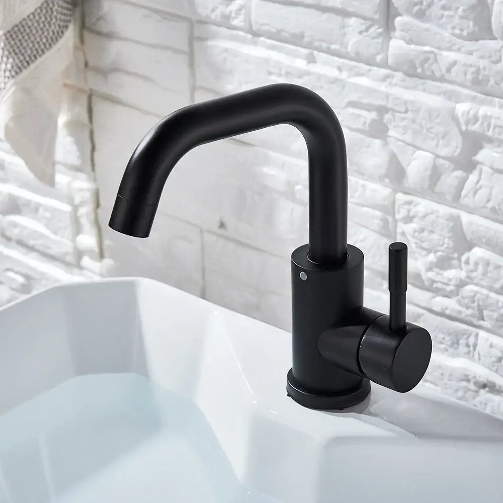 Modern matte black basin faucet with a curved spout and cylindrical base decorbites black basin faucet for bathroom use