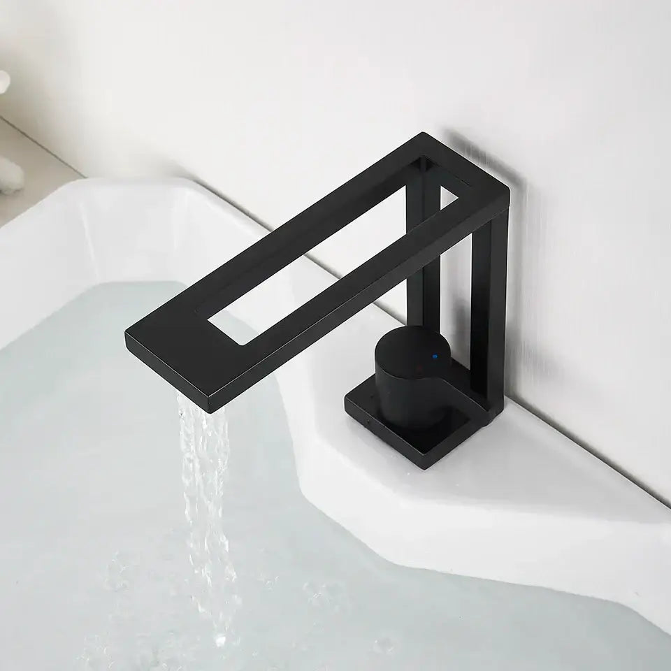 Modern matte black basin faucet with a minimalist rectangular spout and cylindrical handle for bathroom vessel sink