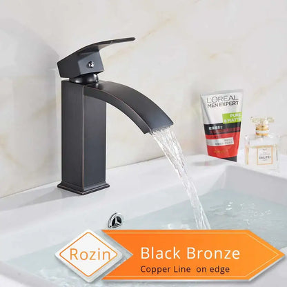 Modern matte black basin mixer faucet with sleek curved spout and copper-lined edges for bathroom use
