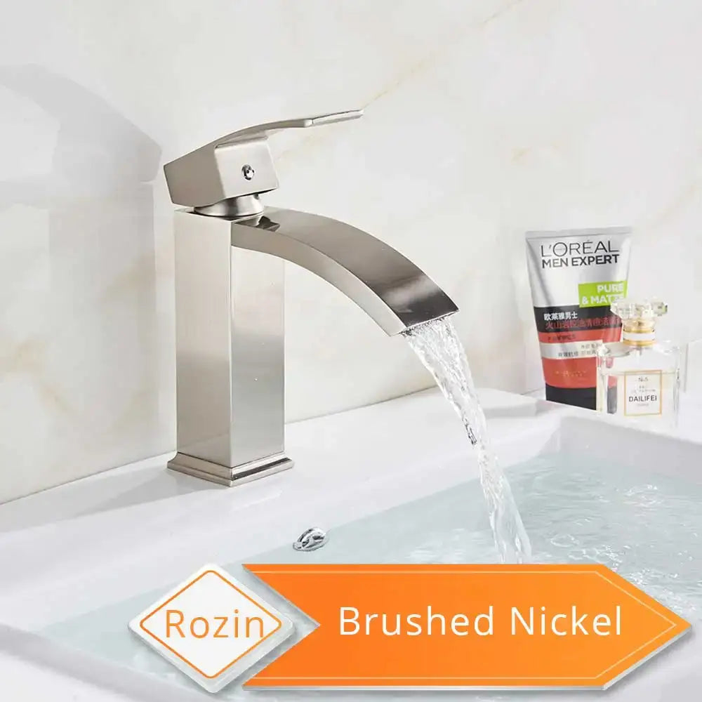 Brushed nickel single-handle basin mixer faucet with sleek modern design and curved spout for bathroom use