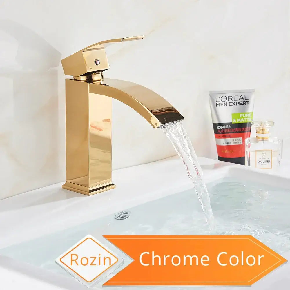 Modern gold-toned basin mixer faucet with a sleek chrome finish and arched spout for stylish bathroom use
