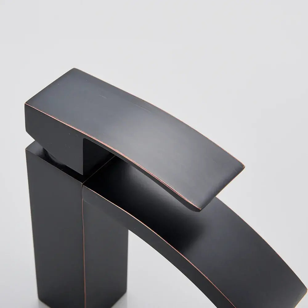 Modern matte black basin mixer faucet with sleek angular design and copper accents for bathroom curved spout use