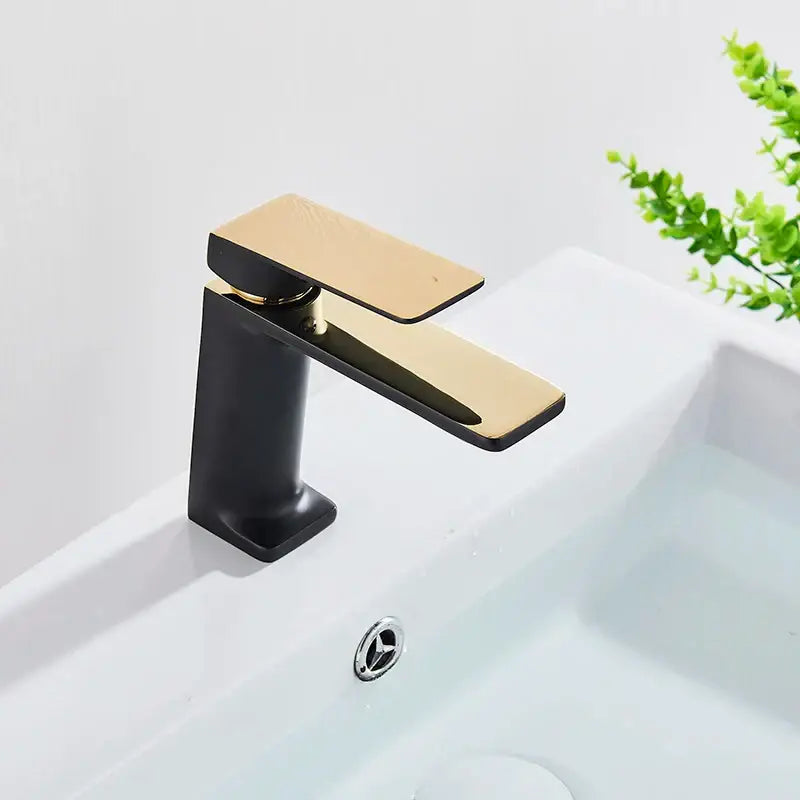 Modern matte black basin mixer tap with polished gold spout and geometric design black basin mixer for bathroom decorbites