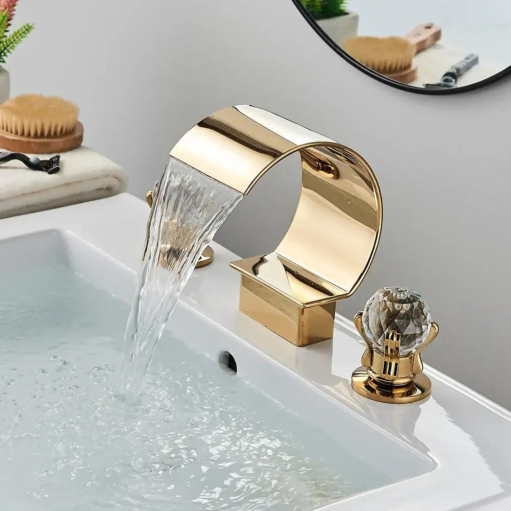 Modern matte black bathroom faucet set featuring a gold waterfall faucet with a crystal knob for sleek bathroom use