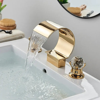 Modern matte black bathroom faucet set featuring a gold waterfall faucet with a crystal knob for sleek bathroom use