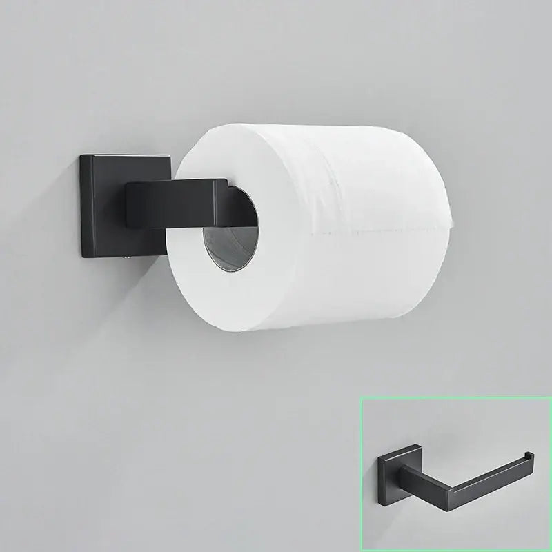 Black matte-finished metal toilet paper holder with square base holding white roll in modern matte black bathroom hardware set