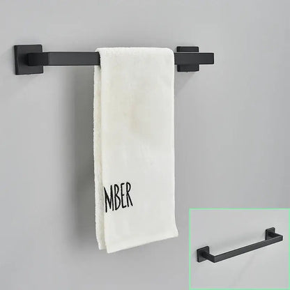 Modern matte black bathroom hardware set featuring a black matte finished metal towel rack holding a white towel decorbites black bathroom