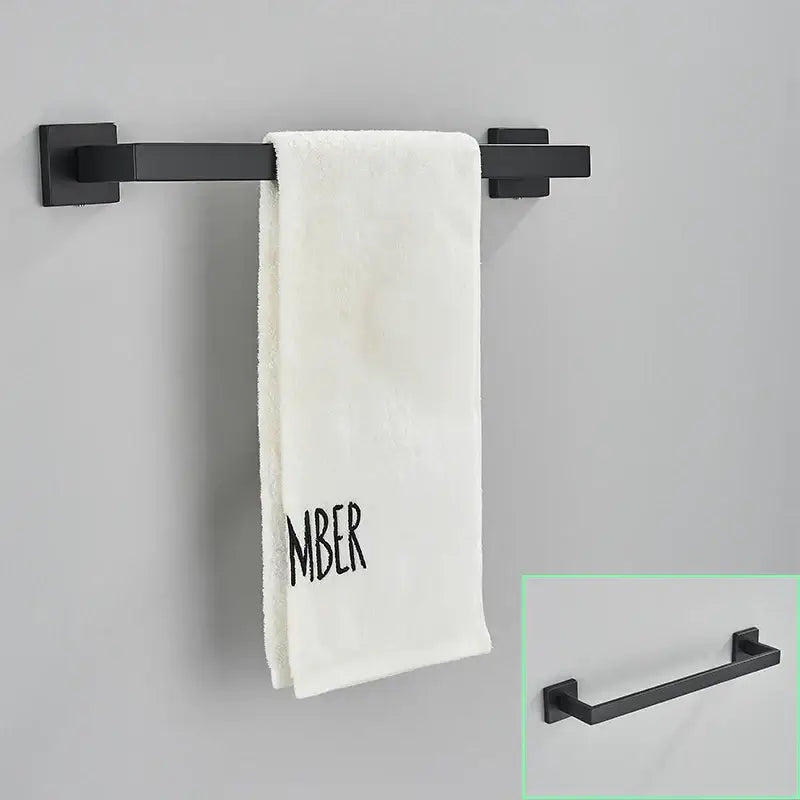 Modern matte black bathroom hardware set featuring a black matte finished metal towel rack holding a white towel decorbites black bathroom