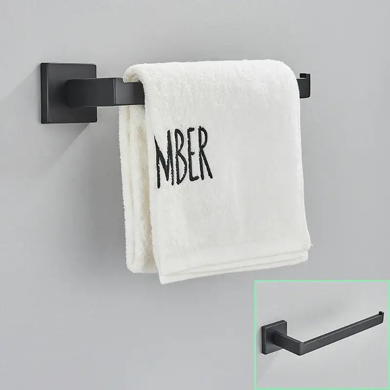 Modern matte black bathroom hardware set with square towel rail holding a white towel on a black bathroom hardware rack