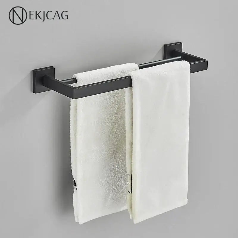 Modern matte black bathroom set featuring a decorbites black bathroom matte metal towel rack with two white towels hanging