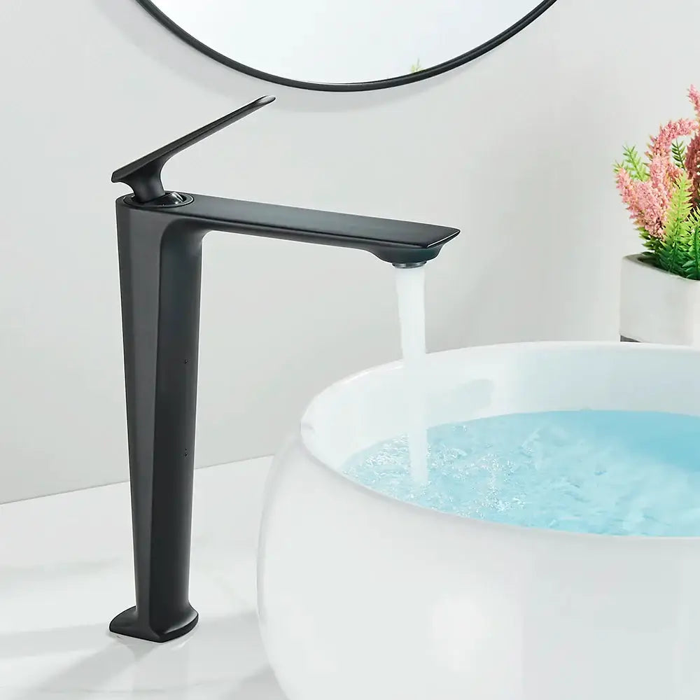 Modern matte black brass bathroom sink faucet with sleek angular design flowing water into white ceramic basin decorbites black brass
