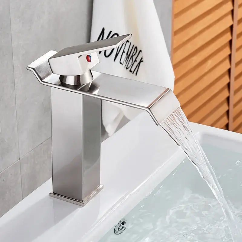 Modern matte black brass bathroom waterfall sink faucet with sleek brushed stainless steel waterfall spout and red indicator light