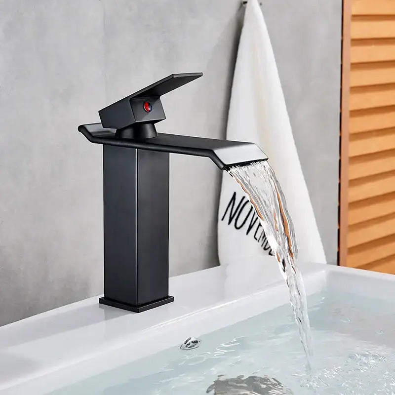 Modern matte black brass bathroom waterfall sink faucet with sleek design and red accent button by decorbites black brass