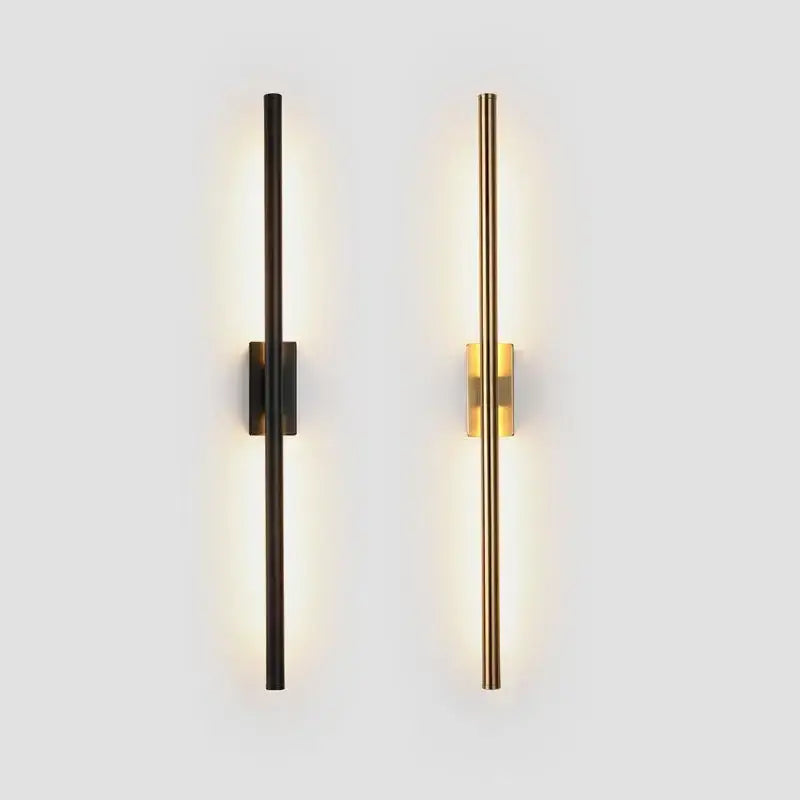 Two modern minimalist wall lights in matte black and decorbites brass gold led with sleek vertical cylindrical design