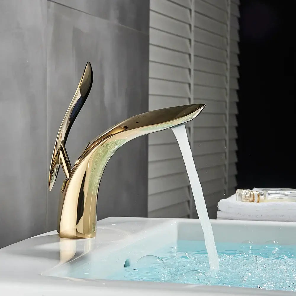 Modern matte black brass washbasin faucet with gold-colored sleek design and polished finish by decorbites brass