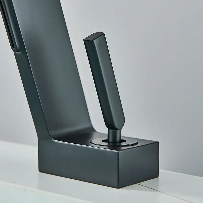 Modern matte black brass waterfall basin faucet with sleek minimalist design and rectangular spout for bathroom use